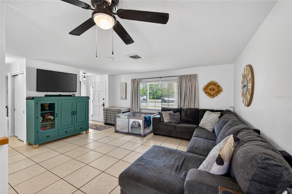 532 Center Road Venice, FL 34285 - Photo 17 of 68 a living room with furniture and a flat screen tv