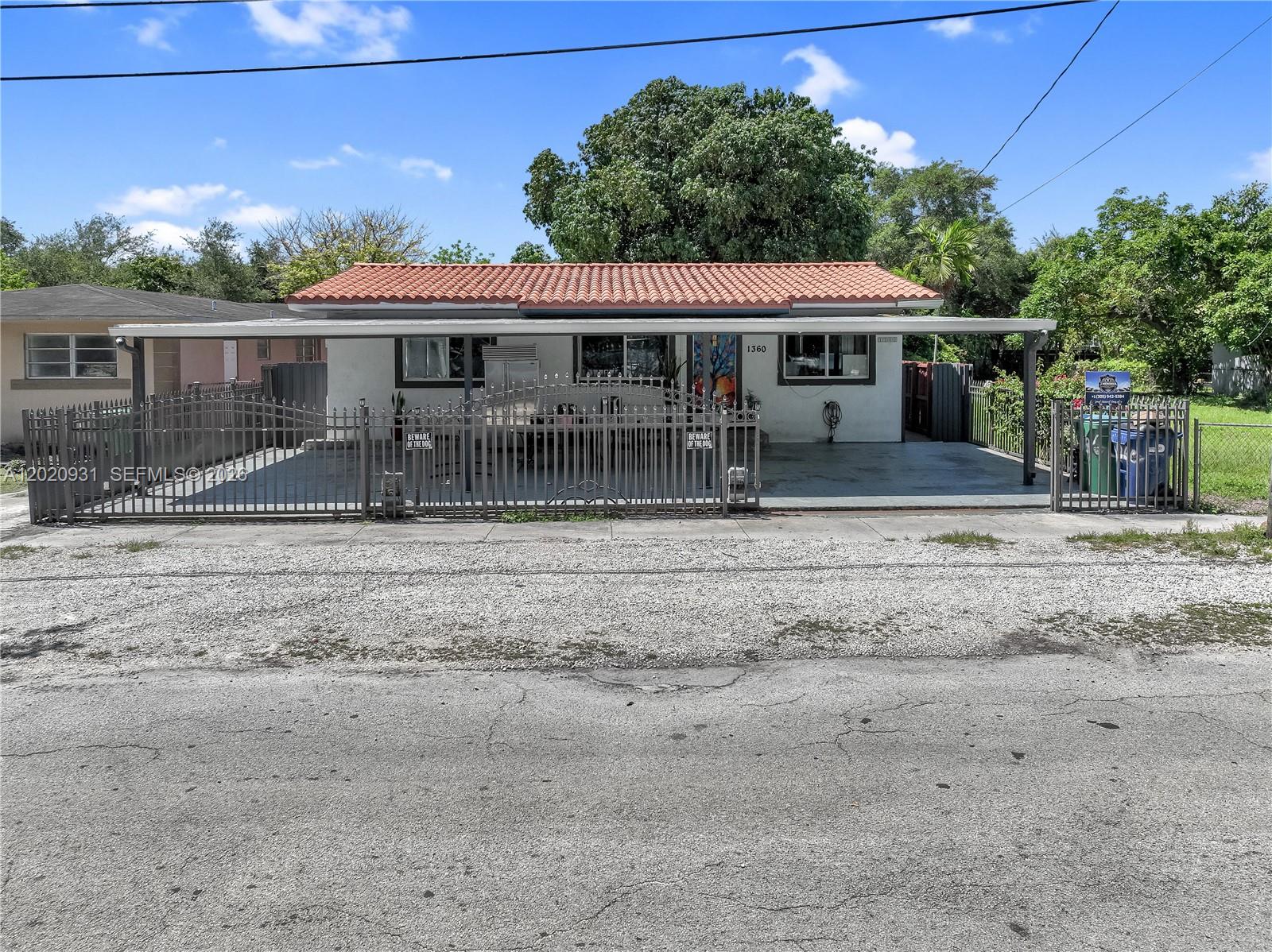 1360 Northwest 77th Street Miami, FL 33147 - Photo 41 of 41 a front view of a house with a yard