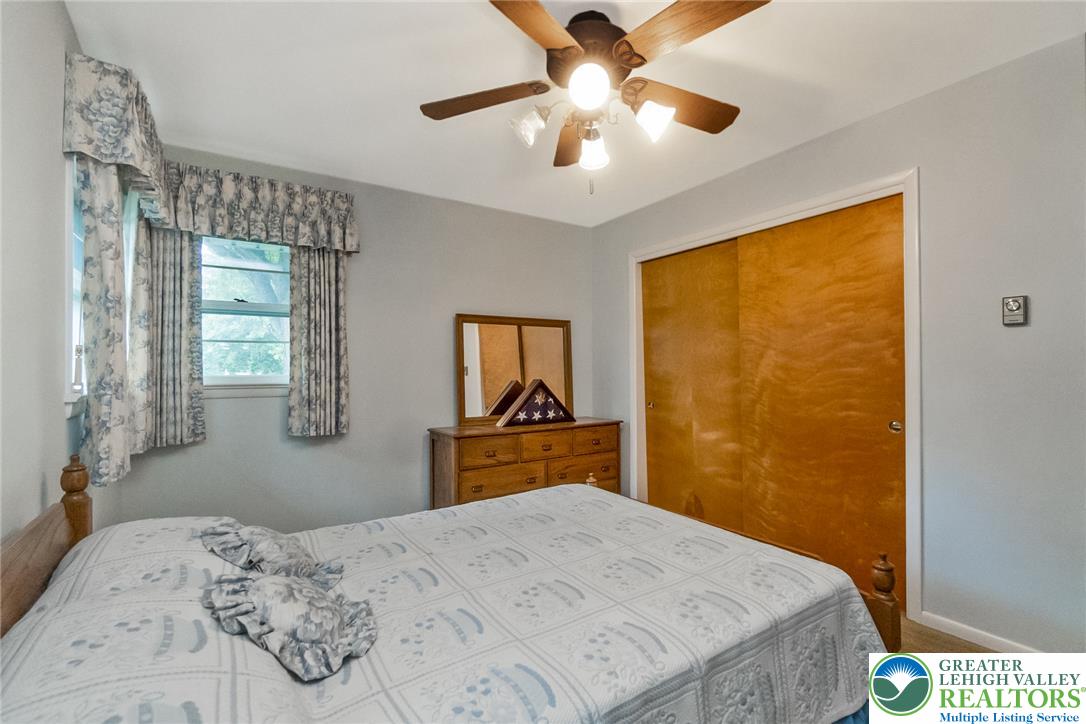 1328 Russett Road Allentown, PA 18104 - Photo 27 of 46 Well-lit bedroom with plush carpeting features an integrated ceiling fan with lighting and ample closet space.