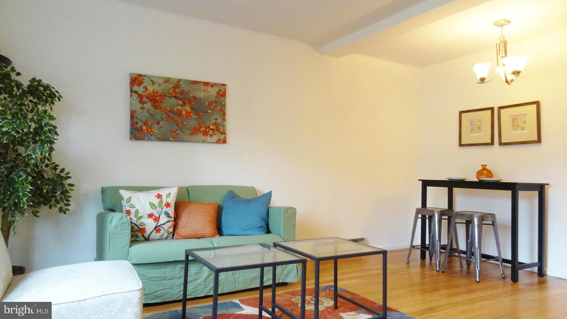 51 Ridge Road, Unit B Greenbelt, MD 20770 - Photo 2 of 8 a view of a livingroom with furniture and wooden floor