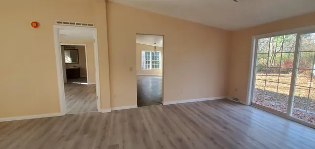 wooden floor in an empty room with a window