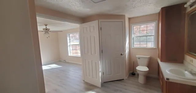 a bathroom with a toilet and a shower