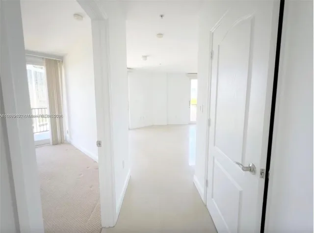 a view of a hallway with a white walls