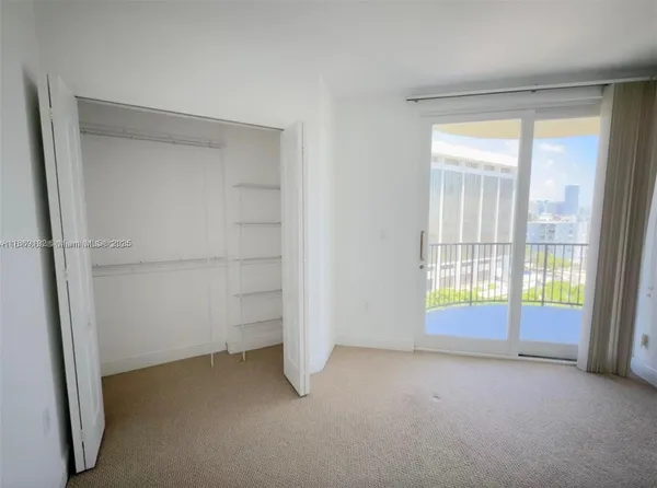 a view of an empty room with a fireplace