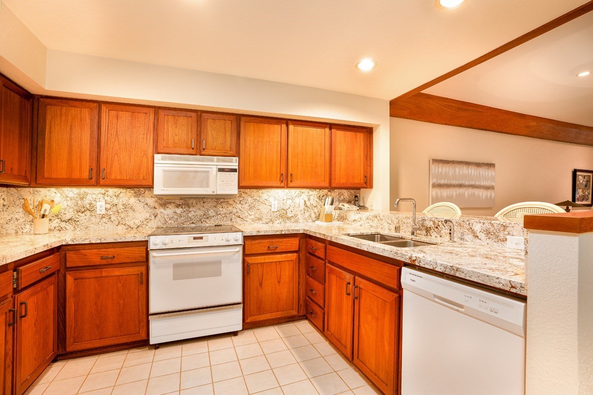 2221 Kapili Road, Unit 52 Koloa, HI 96756 - Photo 5 of 26 a kitchen with stainless steel appliances granite countertop a sink stove and cabinets
