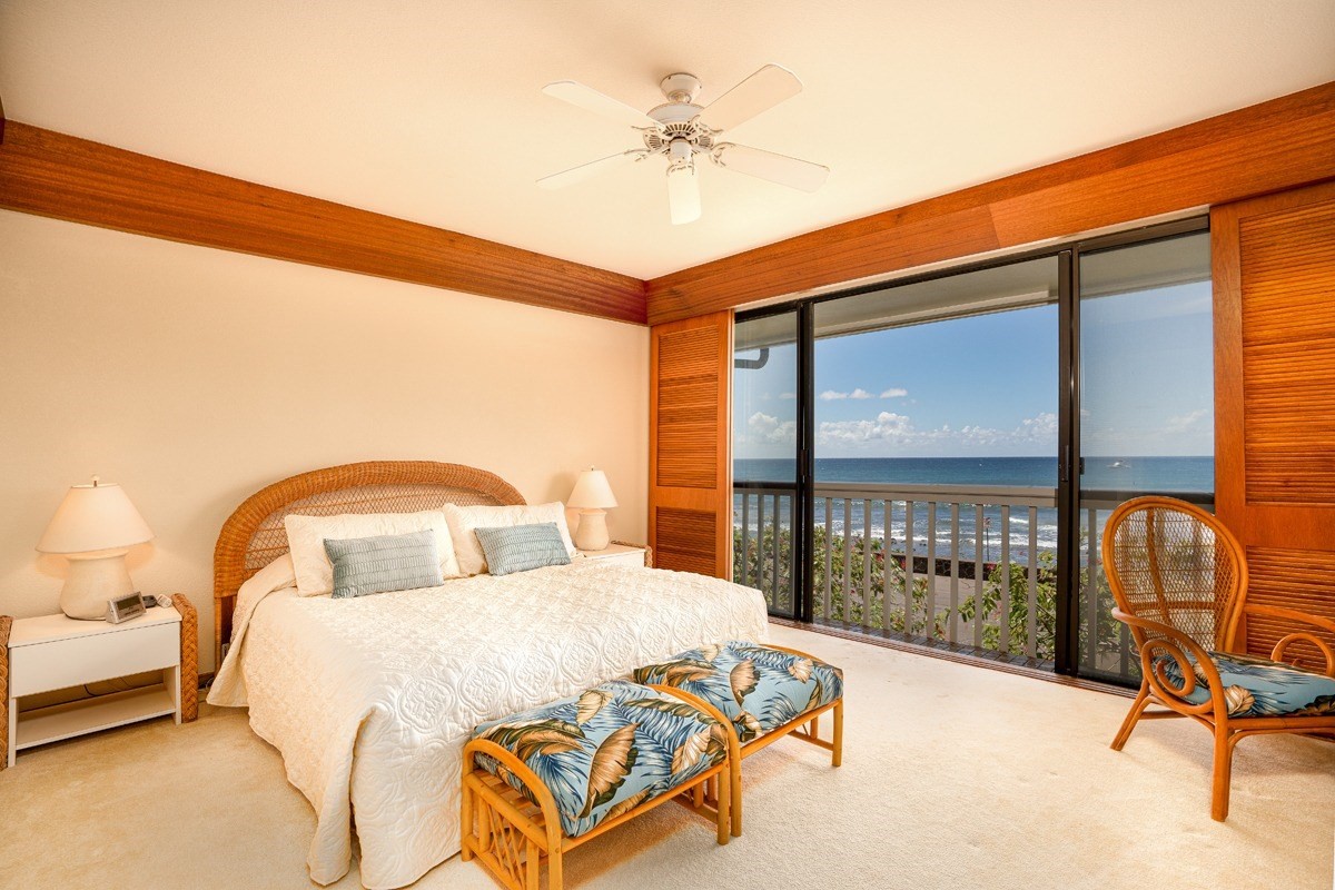 2221 Kapili Road, Unit 52 Koloa, HI 96756 - Photo 7 of 26 a bedroom with a bed and a chandelier