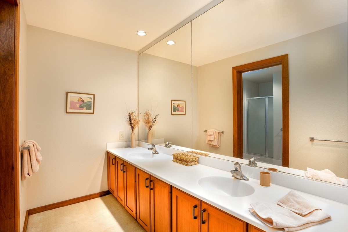 2221 Kapili Road, Unit 52 Koloa, HI 96756 - Photo 8 of 26 a bathroom with double vanity sinks and a mirror