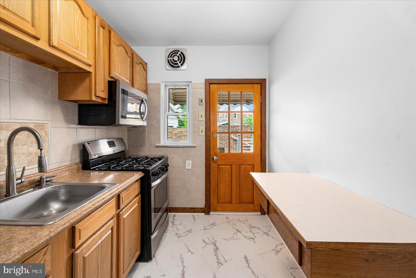 98 Kentway Baltimore, MD 21222 - Photo 12 of 35 a kitchen with stainless steel appliances granite countertop a sink stove and refrigerator