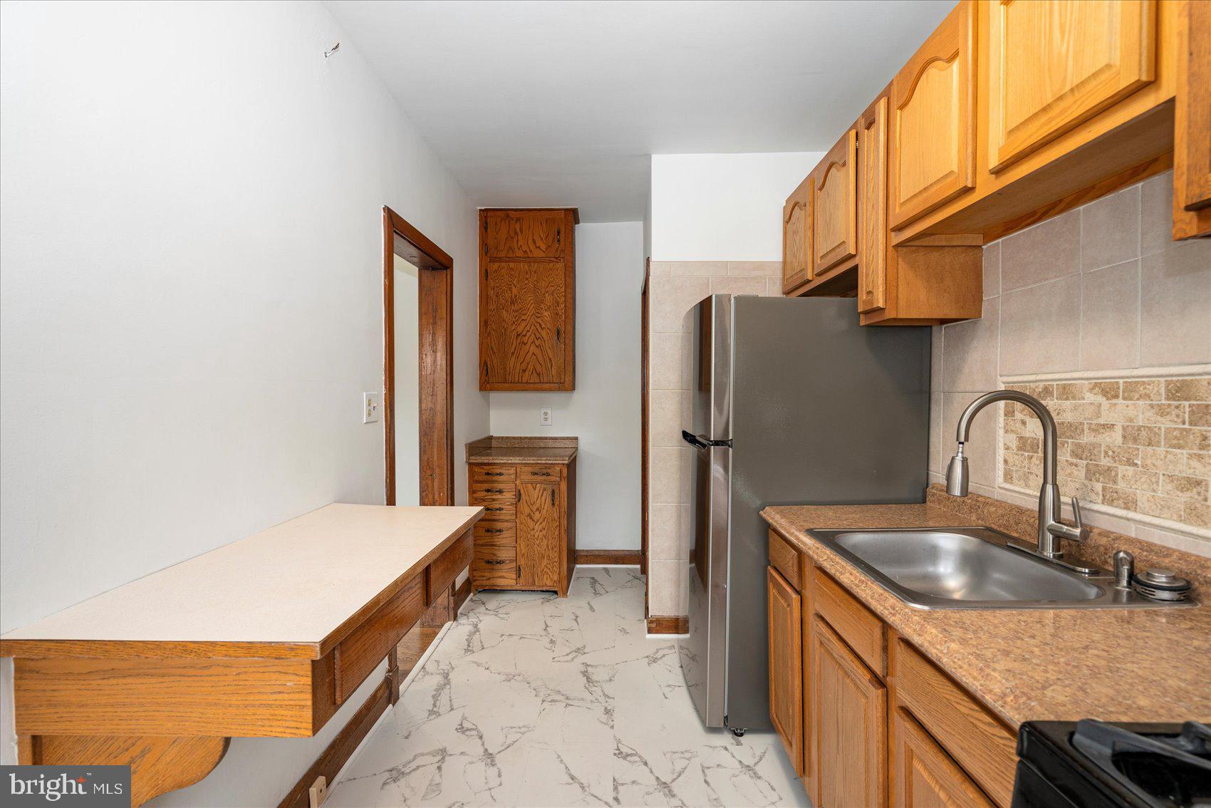 98 Kentway Baltimore, MD 21222 - Photo 13 of 35 a kitchen that has a sink and a refrigerator