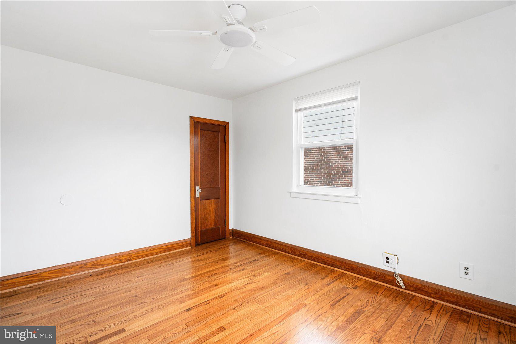 98 Kentway Baltimore, MD 21222 - Photo 17 of 35 an empty room with wooden floor and windows