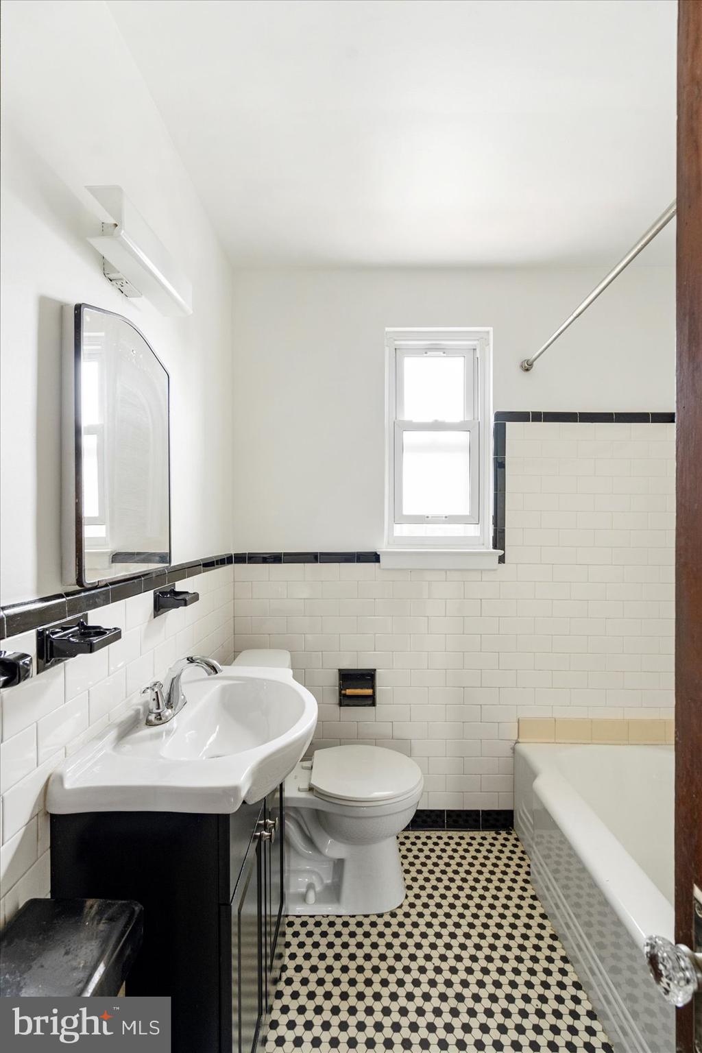 98 Kentway Baltimore, MD 21222 - Photo 23 of 35 a bathroom with a sink a toilet a mirror and shower