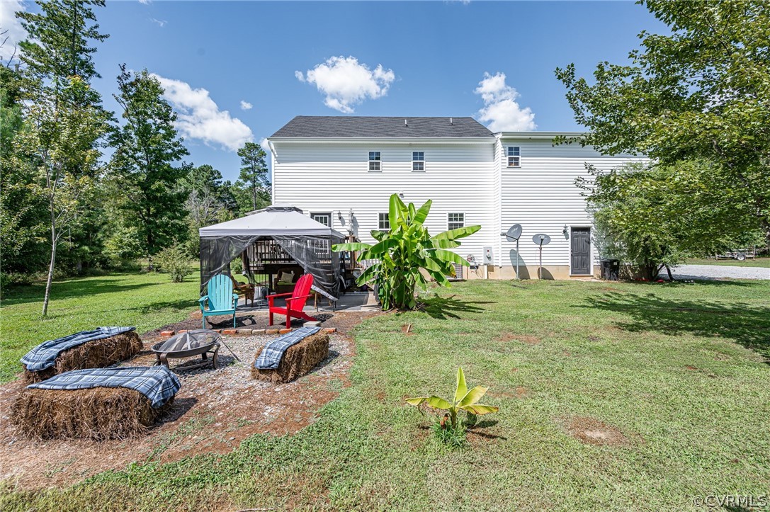 13063 Noel Road Beaverdam, VA 23047 - Photo 39 of 39 a view of a house with backyard sitting area and garden