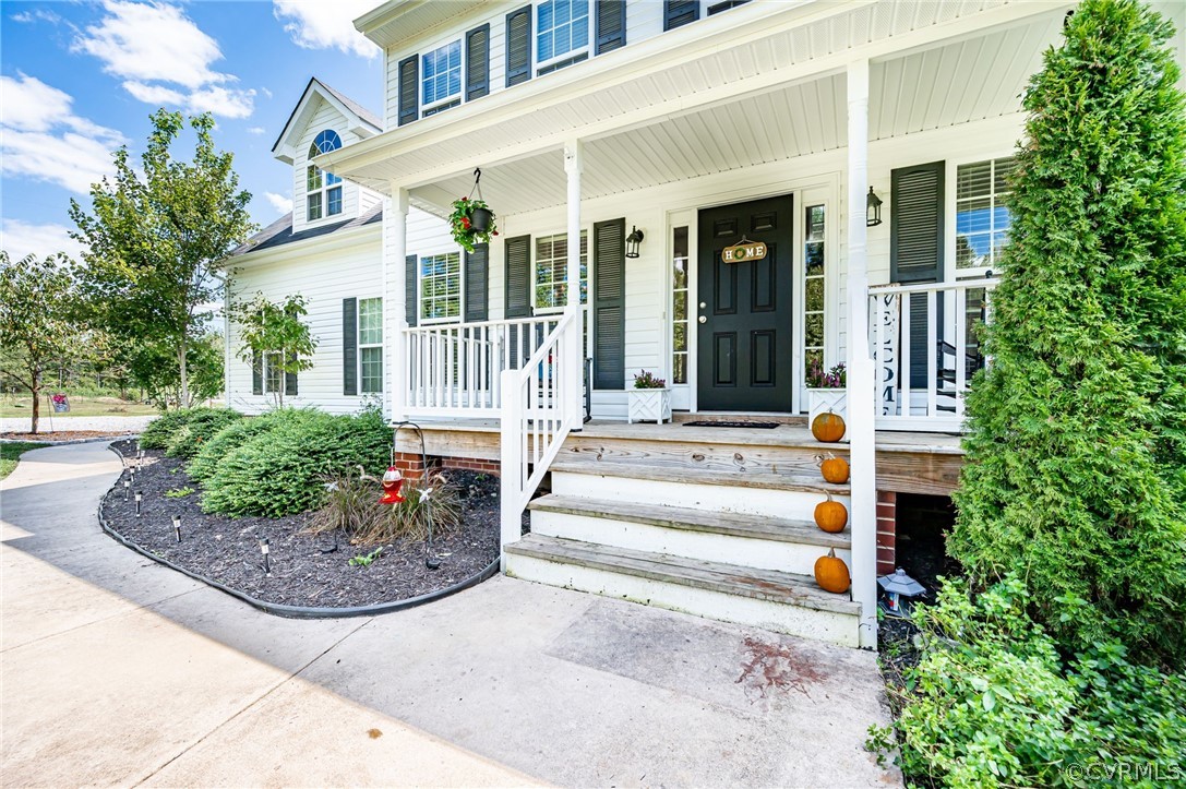 13063 Noel Road Beaverdam, VA 23047 - Photo 7 of 39 a view of a house with potted plants and a fountain