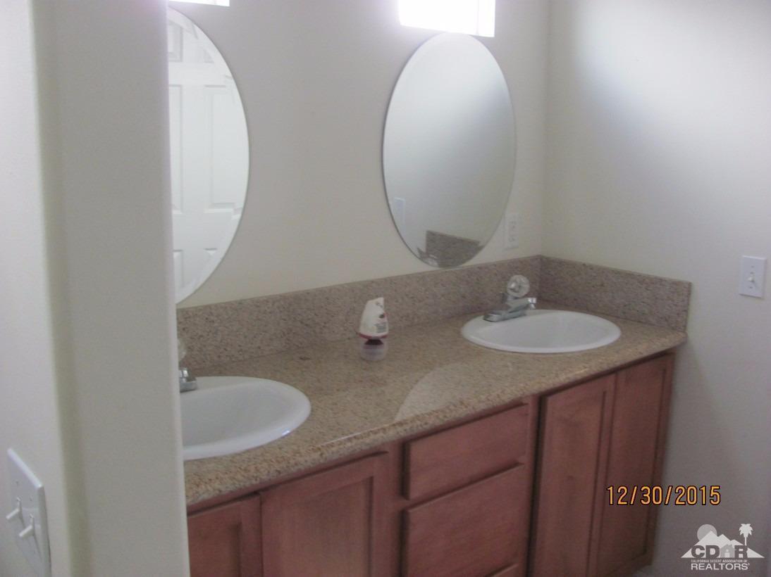 68275 Tortuga Road Cathedral City, CA 92234 - Photo 14 of 18 a bathroom with a granite countertop sink and a mirror