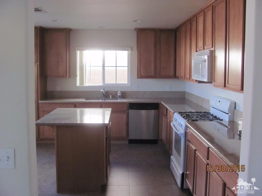 68275 Tortuga Road Cathedral City, CA 92234 - Photo 15 of 18 a kitchen with stainless steel appliances granite countertop a sink a stove and a refrigerator