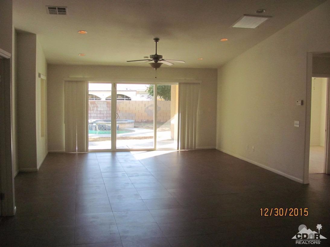 68275 Tortuga Road Cathedral City, CA 92234 - Photo 5 of 18 an empty room with wooden floor and windows