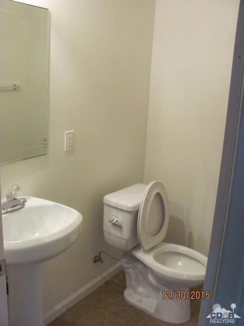 68275 Tortuga Road Cathedral City, CA 92234 - Photo 8 of 18 a white toilet sitting next to a white sink