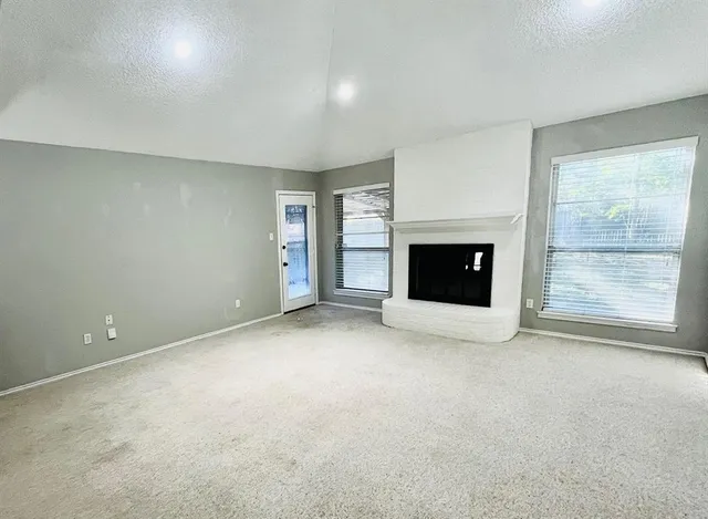 an empty room with furniture and a fireplace