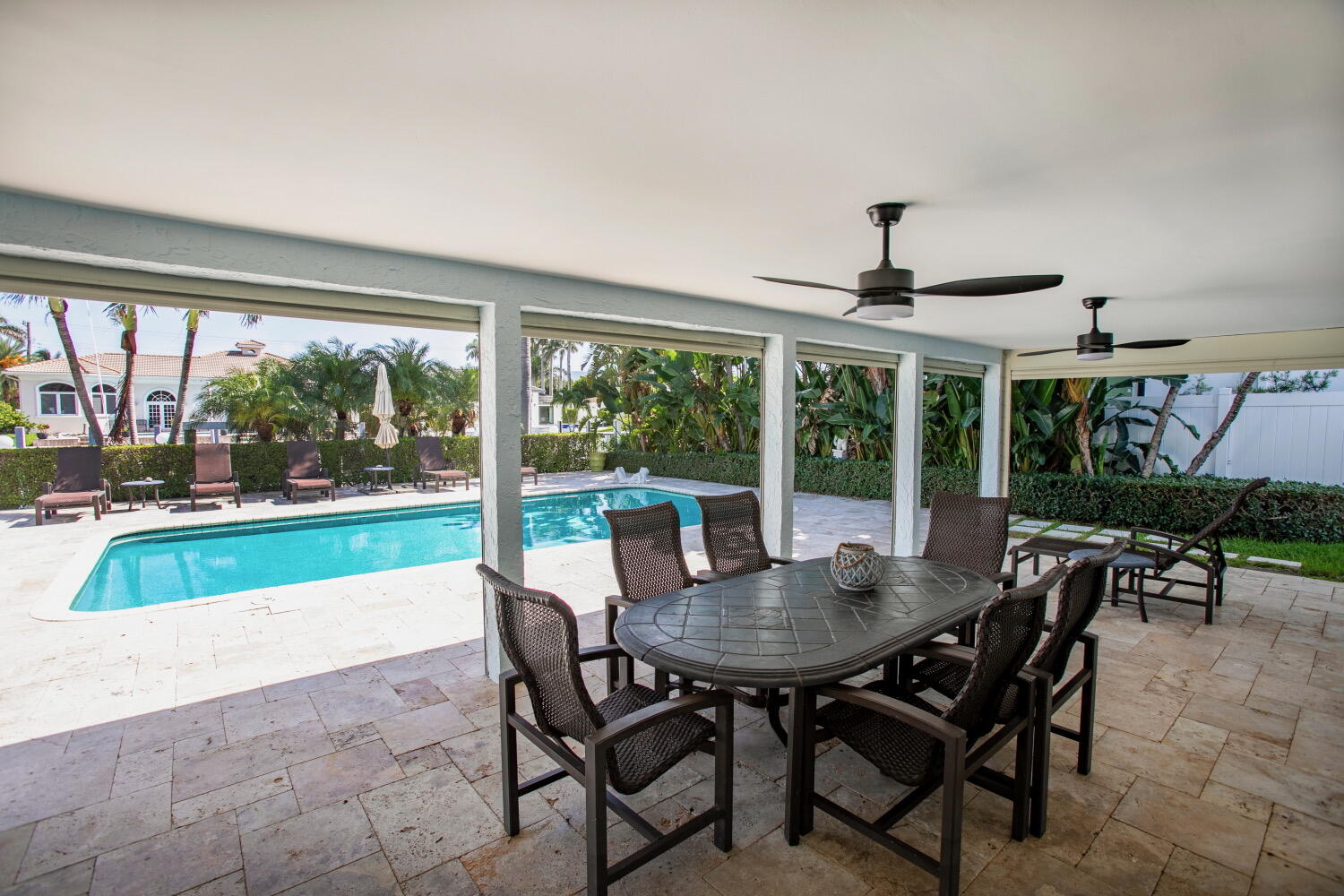 2631 Northeast 48th Street Lighthouse Point, FL 33064 - Photo 1 of 16 a view of a patio with a table chairs and a table