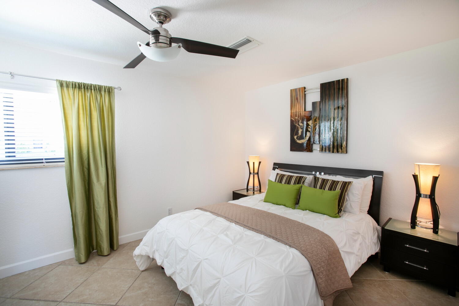 2631 Northeast 48th Street Lighthouse Point, FL 33064 - Photo 10 of 16 a bedroom with a bed and a painting