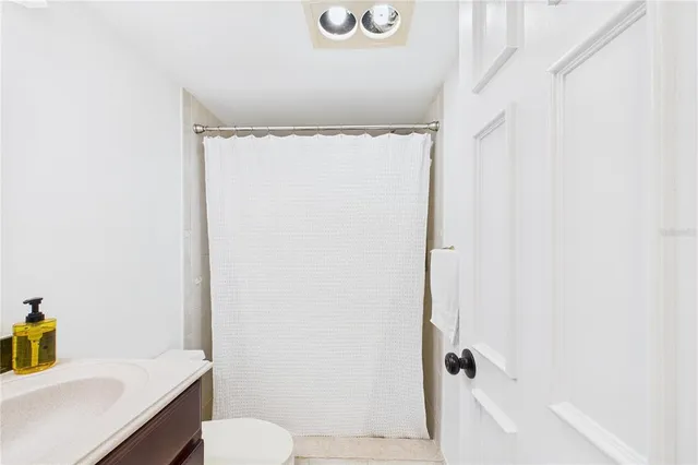 a kitchen with stainless steel appliances kitchen island granite countertop a refrigerator stove and sink