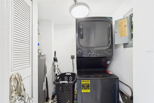 a kitchen with granite countertop stainless steel appliances a stove a sink and a microwave