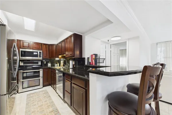 a spacious bathroom with a toilet a sink and a mirror