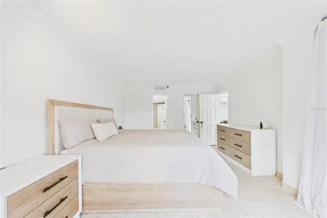 a large white bed in a white room