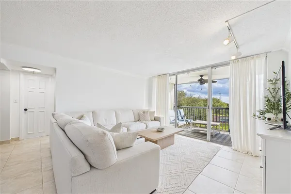 a living room with furniture and a large window