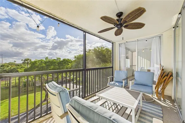 a balcony view with a large window and a chandelier
