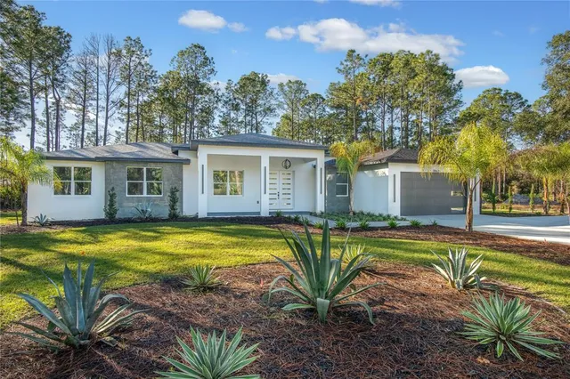 a view of a house with pool and a yard