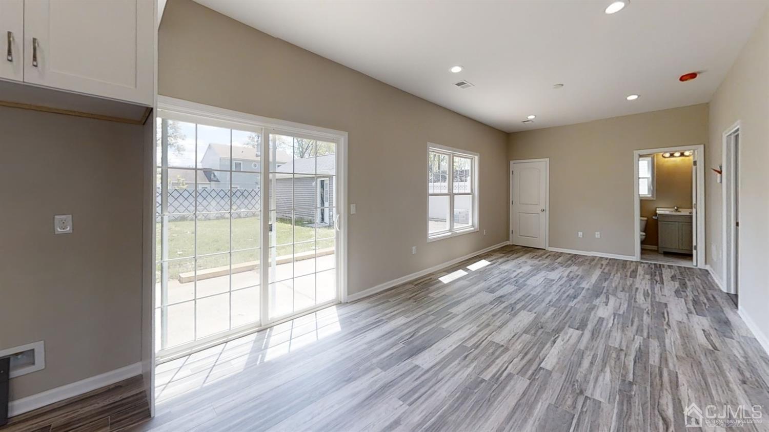 16 Idlewild Road Edison, NJ 08817 - Photo 6 of 15 a view of empty room with wooden floor and fan