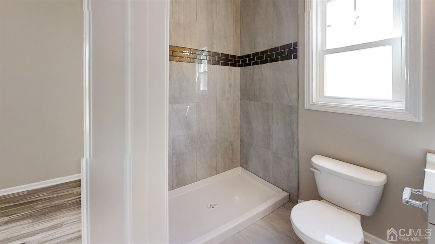 16 Idlewild Road Edison, NJ 08817 - Photo 7 of 15 a white toilet sitting next to a bathroom sink and a shower