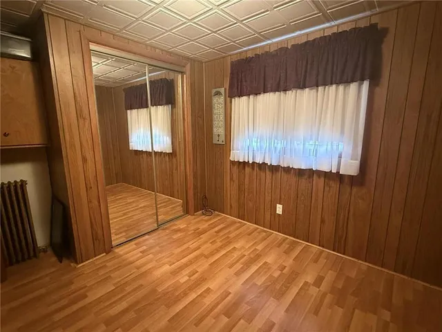 a view of a room with a wooden floor and a window