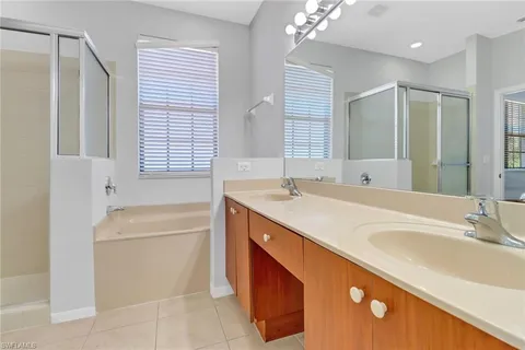 a bathroom with a tub sink and mirror