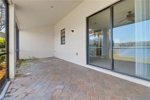 an empty room with sliding door and wooden floor