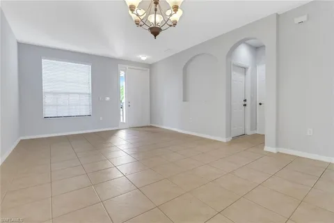 wooden floor in an empty room with a chandelier