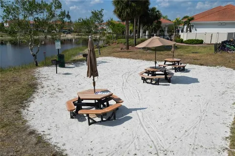 a view of a backyard with chairs and a umbrella
