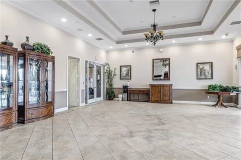 a view of a livingroom with a furniture ceiling fan and window