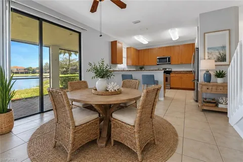 a dining room with furniture and a large window