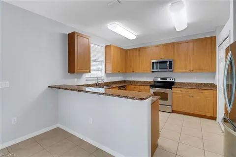 a kitchen with a stove a sink and a microwave