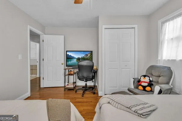 a bedroom with furniture and a window