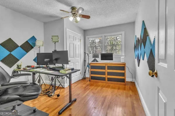 a view of a workspace with furniture and a window