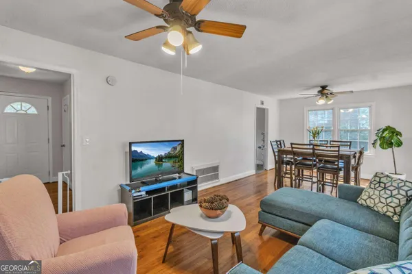 a living room with furniture a dining table and a piano
