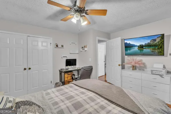 a bedroom with a bed and a flat screen tv