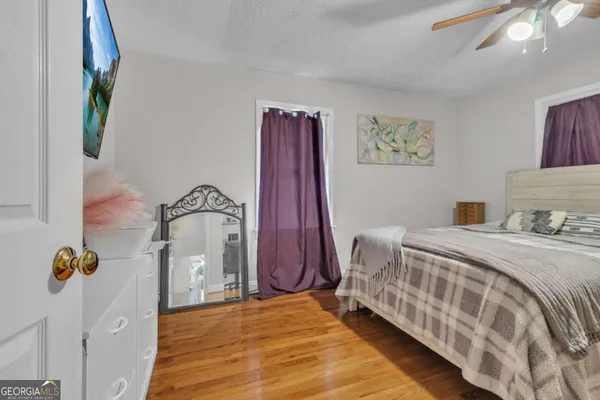 a bedroom with a bed and a painting on the wall