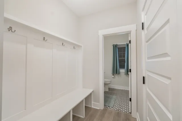 a view of a hallway with wooden floor and entryway