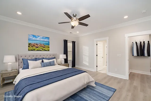 a bedroom with a large bed and a ceiling fan