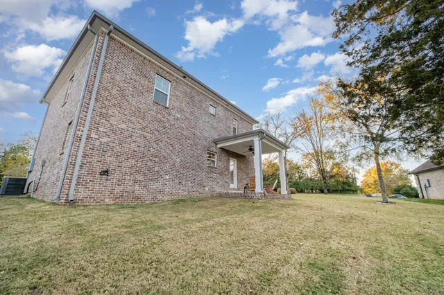 a backyard of a house with large trees