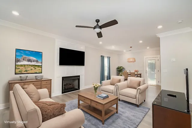 a living room with furniture a flat screen tv and a fireplace